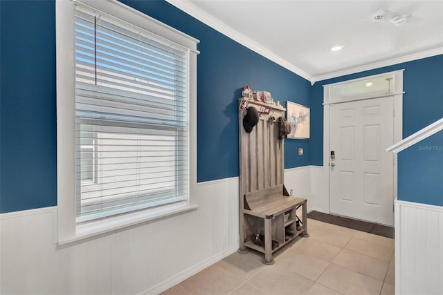mudroom with tile patterned floors, crown molding, and a wainscoted wall