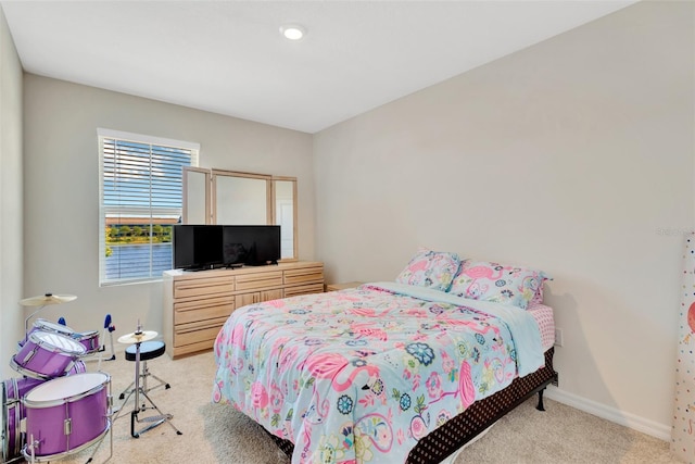 carpeted bedroom featuring baseboards