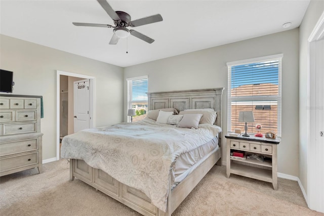 bedroom with baseboards, a ceiling fan, and light carpet