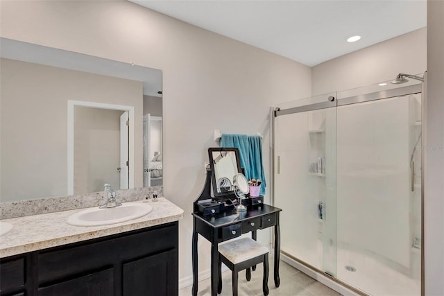 bathroom with a sink, tile patterned floors, a shower stall, and double vanity