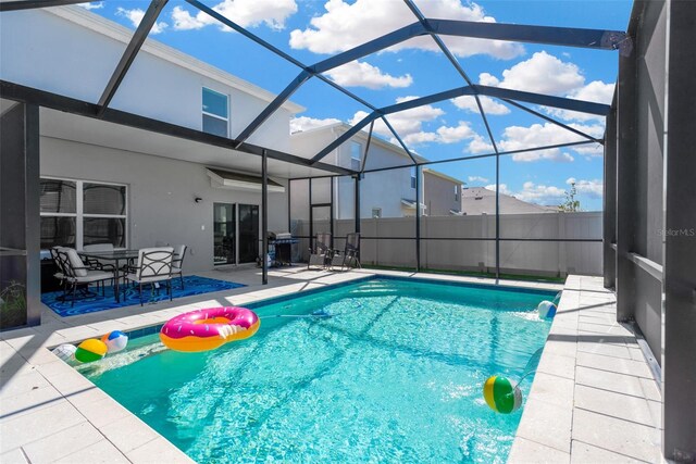 view of pool with a fenced in pool, a patio area, grilling area, and glass enclosure