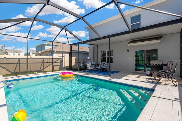 view of swimming pool with a patio area, a fenced in pool, and glass enclosure