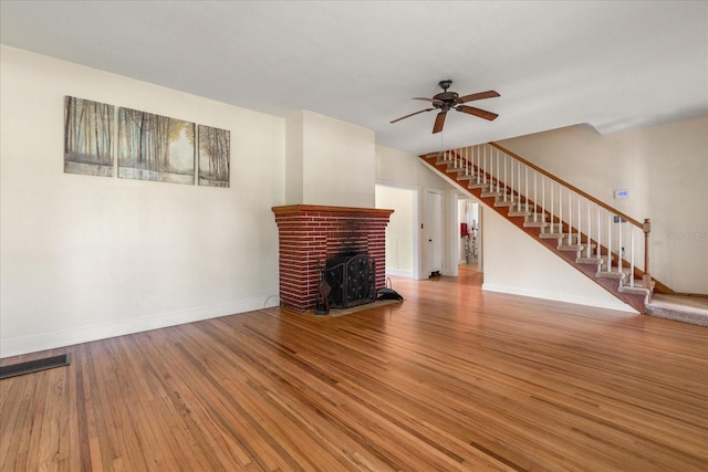 1905 Mckinley St, Clearwater, FL 33765 - unfurnished living room with stairway, ceiling fan, baseboards, and wood finished floors