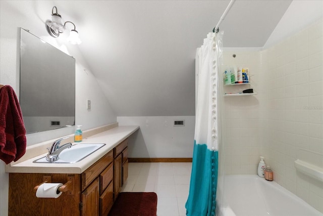 1905 Mckinley St, Clearwater, FL 33765 - full bathroom with baseboards, vaulted ceiling, vanity, and shower / bath combo with shower curtain