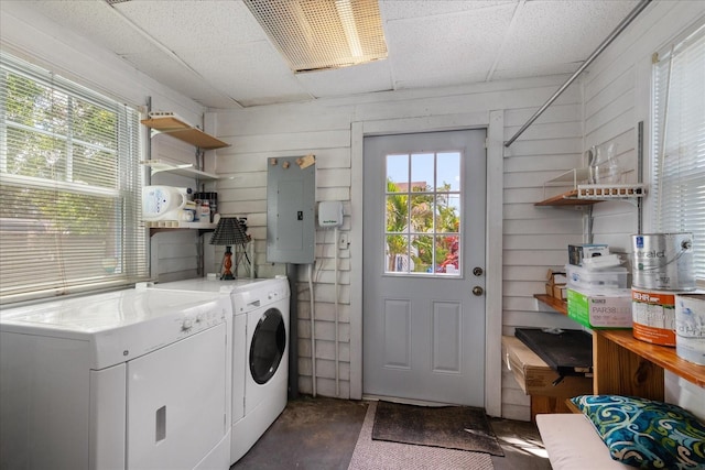 1905 Mckinley St, Clearwater, FL 33765 - washroom featuring electric panel, laundry area, a healthy amount of sunlight, and separate washer and dryer