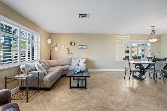 8763 Matthew St, Seminole, FL 33772 - living room with visible vents, baseboards, and light tile patterned floors