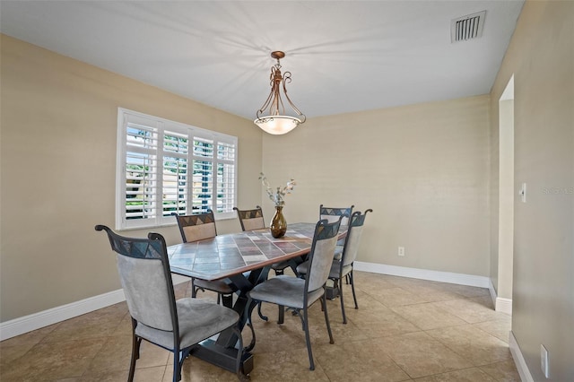 8763 Matthew St, Seminole, FL 33772 - dining room with visible vents, baseboards, and light tile patterned floors