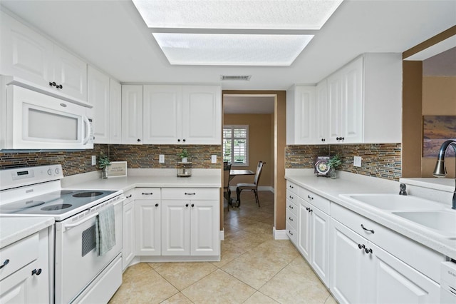 8763 Matthew St, Seminole, FL 33772 - kitchen featuring tasteful backsplash, white appliances, light tile patterned flooring, visible vents, and a sink