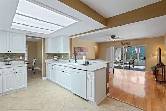 8763 Matthew St, Seminole, FL 33772 - kitchen featuring tasteful backsplash, dishwasher, light countertops, and a sink