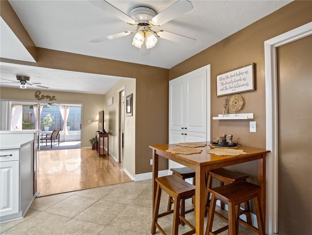 8763 Matthew St, Seminole, FL 33772 - dining room featuring light tile patterned floors, baseboards, and a ceiling fan