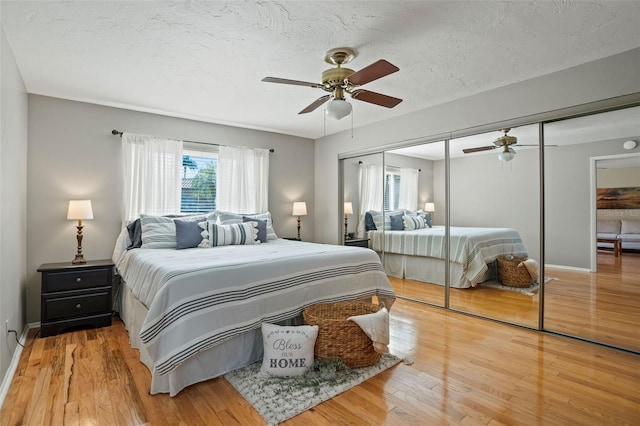 8763 Matthew St, Seminole, FL 33772 - bedroom with a closet, baseboards, ceiling fan, a textured ceiling, and wood finished floors