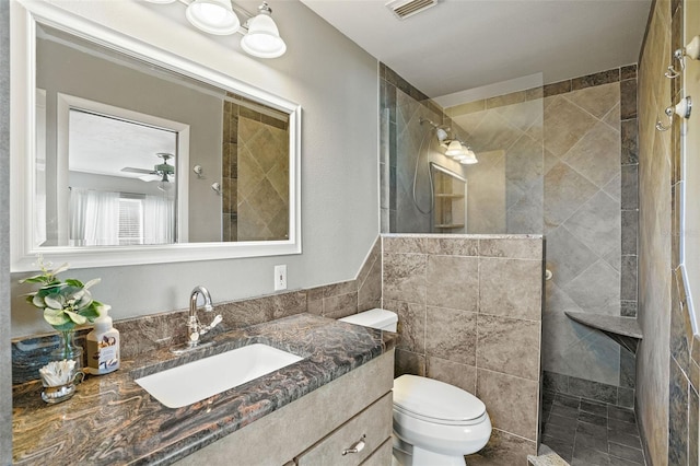 8763 Matthew St, Seminole, FL 33772 - bathroom featuring a walk in shower, vanity, visible vents, toilet, and tile walls