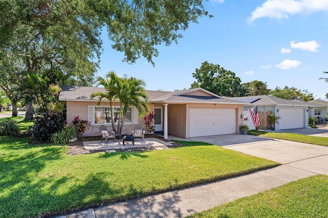 8763 Matthew St, Seminole, FL 33772 - ranch-style home with brick siding, driveway, an attached garage, and a front lawn