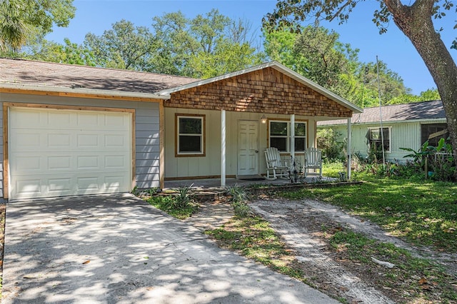 186 Grand Ave, Brooksville, FL 34604 - view of front of house with a porch, an attached garage, driveway, and roof with shingles