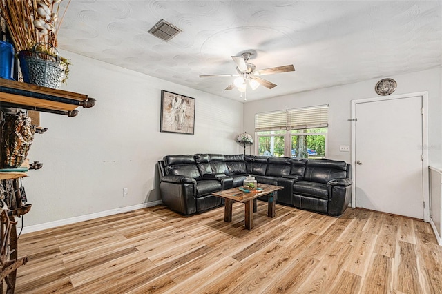 186 Grand Ave, Brooksville, FL 34604 - living room with a ceiling fan, light wood-style floors, and baseboards