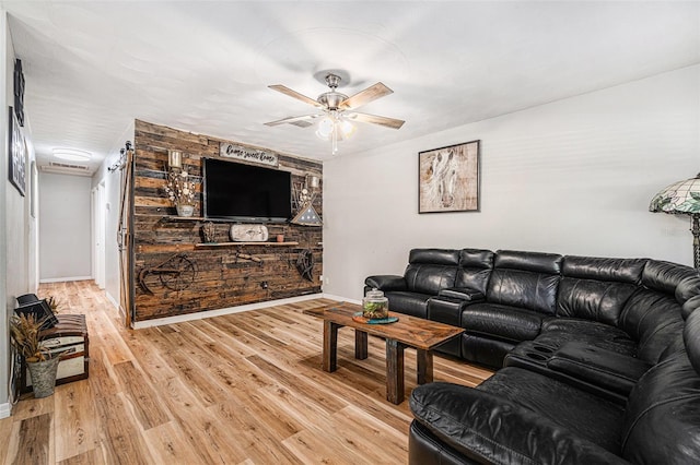 186 Grand Ave, Brooksville, FL 34604 - living area featuring a ceiling fan, light wood finished floors, and baseboards
