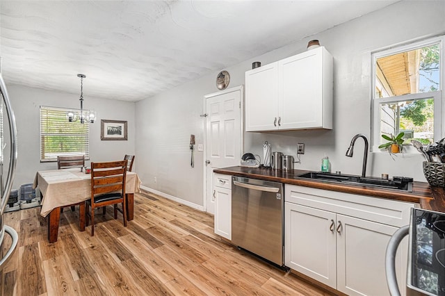 186 Grand Ave, Brooksville, FL 34604 - kitchen featuring stainless steel dishwasher, wood counters, a sink, and light wood-type flooring