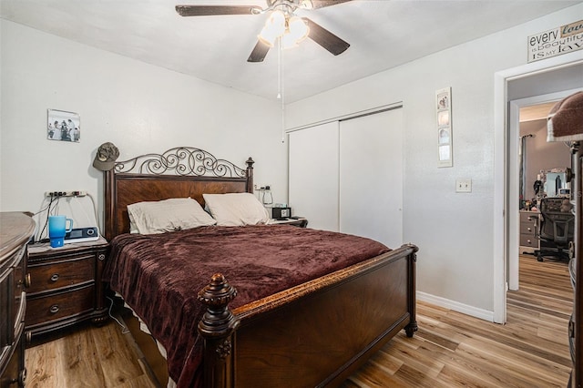 186 Grand Ave, Brooksville, FL 34604 - bedroom featuring wood finished floors, a closet, baseboards, and a ceiling fan