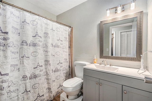 186 Grand Ave, Brooksville, FL 34604 - bathroom featuring toilet, vanity, and curtained shower