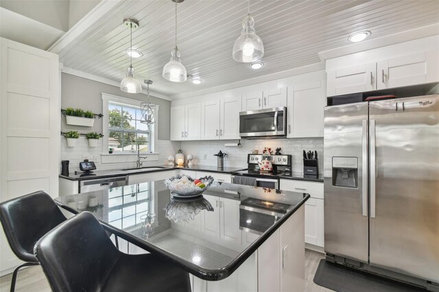2704 W Main St, Tampa, FL 33607 - kitchen with a sink, white cabinetry, open shelves, a kitchen island, and appliances with stainless steel finishes