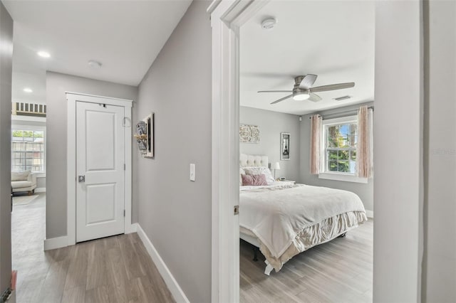 2704 W Main St, Tampa, FL 33607 - bedroom featuring light wood-type flooring, visible vents, baseboards, and multiple windows