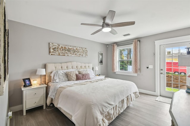 2704 W Main St, Tampa, FL 33607 - bedroom with access to exterior, baseboards, visible vents, multiple windows, and wood finished floors