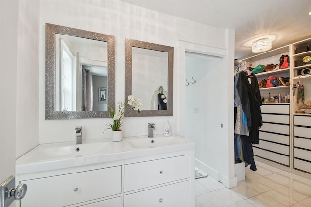 2704 W Main St, Tampa, FL 33607 - full bath with tile patterned flooring, double vanity, a sink, and a walk in closet