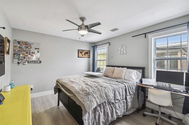 2704 W Main St, Tampa, FL 33607 - bedroom featuring baseboards, a ceiling fan, and wood finished floors
