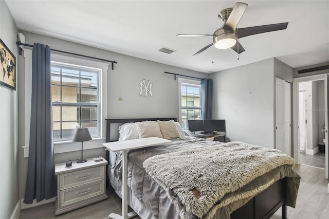 2704 W Main St, Tampa, FL 33607 - bedroom featuring ceiling fan, baseboards, wood finished floors, and visible vents