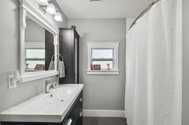 2704 W Main St, Tampa, FL 33607 - bathroom featuring tile patterned floors, baseboards, and vanity