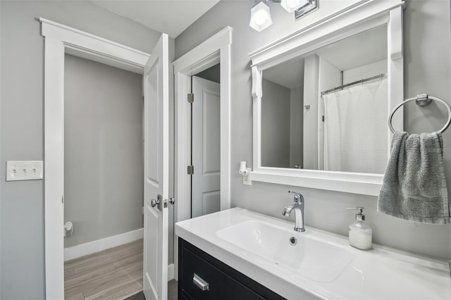 2704 W Main St, Tampa, FL 33607 - full bathroom with baseboards, wood finished floors, and vanity