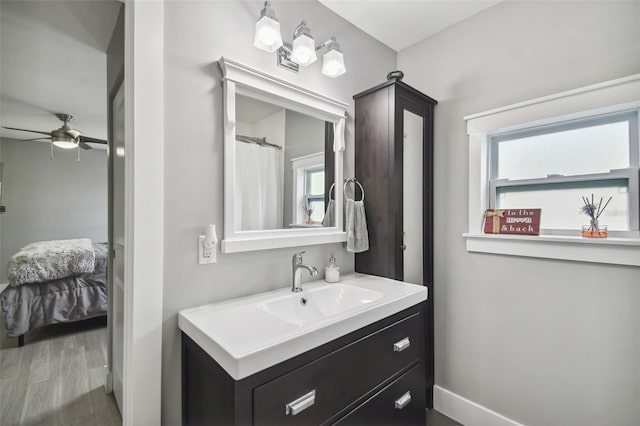 2704 W Main St, Tampa, FL 33607 - bathroom with a ceiling fan, wood finished floors, vanity, baseboards, and ensuite bath
