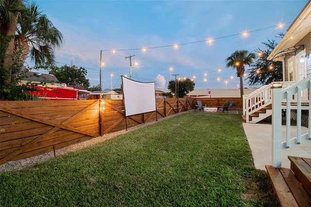 2704 W Main St, Tampa, FL 33607 - yard at dusk featuring a patio and a fenced backyard
