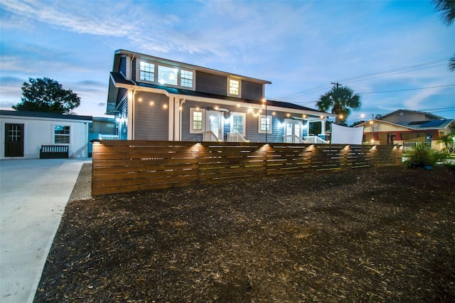 2704 W Main St, Tampa, FL 33607 - view of front of property featuring concrete driveway, covered porch, and a fenced front yard