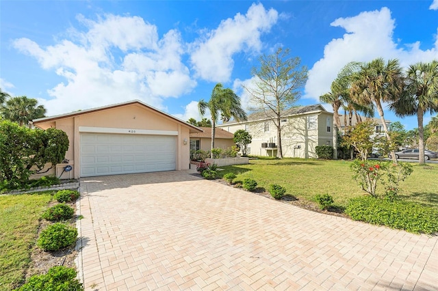 4120 Marine Pkwy, New Port Richey, FL 34652 - view of front facade with a front yard, an attached garage, decorative driveway, and stucco siding