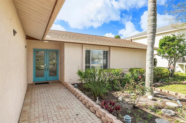 4120 Marine Pkwy, New Port Richey, FL 34652 - entrance to property featuring french doors, stucco siding, and roof with shingles
