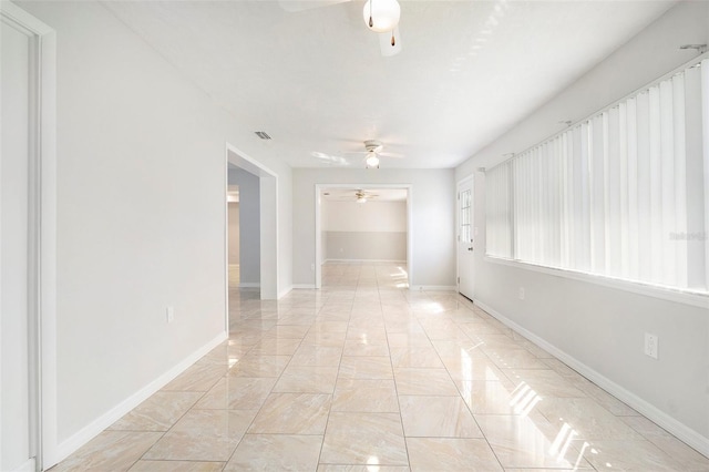 4120 Marine Pkwy, New Port Richey, FL 34652 - spare room featuring baseboards, visible vents, marble finish floor, and a ceiling fan