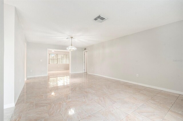 4120 Marine Pkwy, New Port Richey, FL 34652 - spare room featuring an inviting chandelier, baseboards, and visible vents
