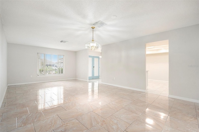 4120 Marine Pkwy, New Port Richey, FL 34652 - spare room featuring a textured ceiling, marble finish floor, baseboards, and visible vents