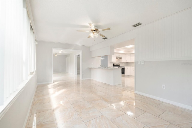 4120 Marine Pkwy, New Port Richey, FL 34652 - unfurnished living room featuring visible vents, baseboards, a ceiling fan, and marble finish floor