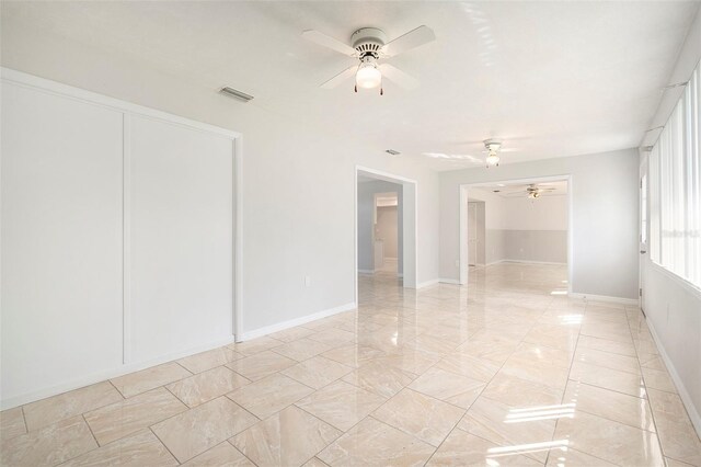 4120 Marine Pkwy, New Port Richey, FL 34652 - spare room featuring marble finish floor, baseboards, a ceiling fan, and visible vents