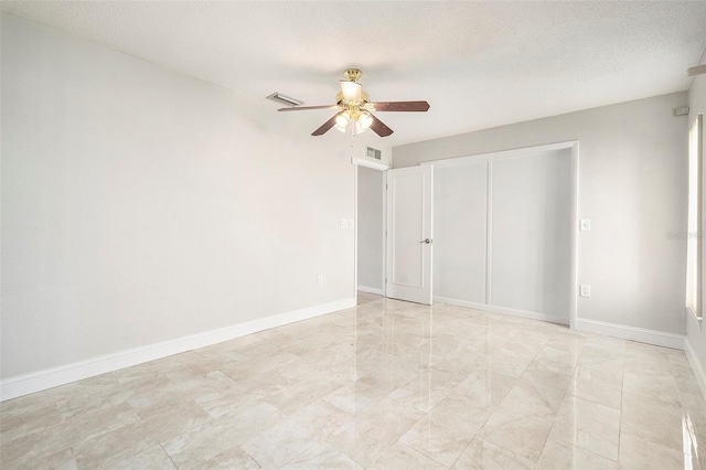 4120 Marine Pkwy, New Port Richey, FL 34652 - unfurnished bedroom featuring a textured ceiling, a closet, a ceiling fan, visible vents, and baseboards