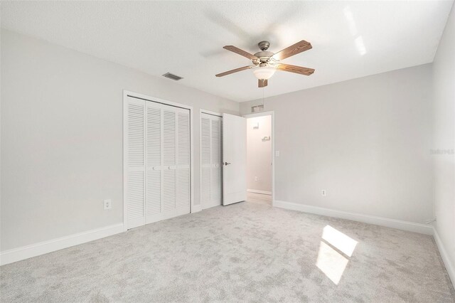 4120 Marine Pkwy, New Port Richey, FL 34652 - unfurnished bedroom with visible vents, baseboards, multiple closets, and carpet floors