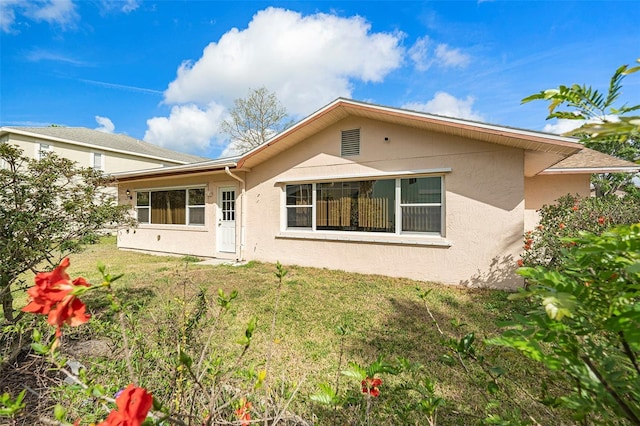 4120 Marine Pkwy, New Port Richey, FL 34652 - back of property featuring a lawn and stucco siding