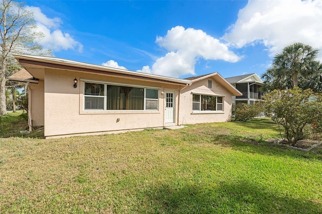 4120 Marine Pkwy, New Port Richey, FL 34652 - back of house with a yard and stucco siding