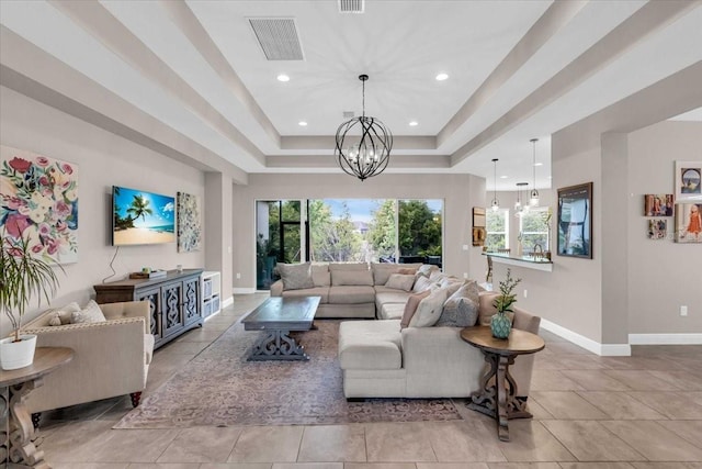 living room featuring a notable chandelier, baseboards, recessed lighting, visible vents, and a raised ceiling