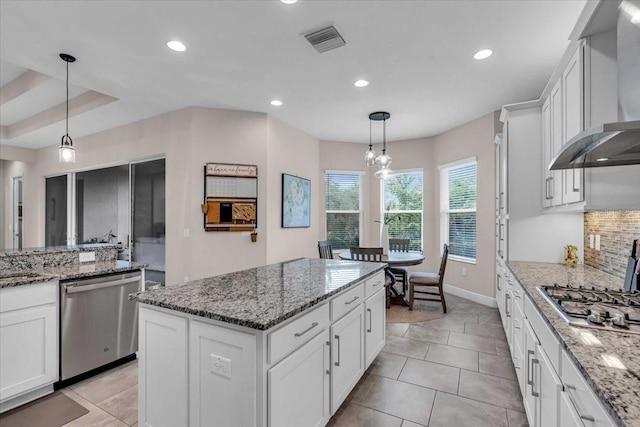 kitchen featuring wall chimney range hood, white cabinetry, visible vents, recessed lighting, and stainless steel appliances