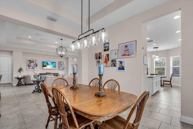 dining room with visible vents, light tile patterned floors, an inviting chandelier, a tray ceiling, and recessed lighting