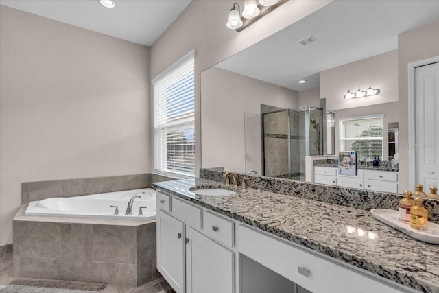 full bath with a shower stall, a bath, vanity, and visible vents