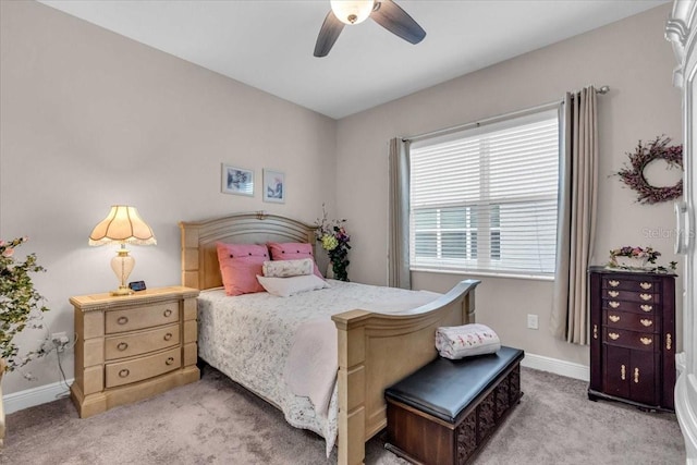 bedroom with ceiling fan, baseboards, and carpet floors
